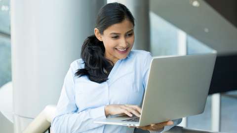 Young woman resting hand on laptop